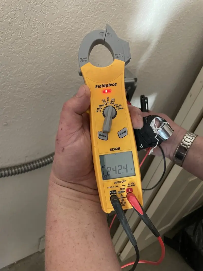 Voltage testing with clamp meter during Outlet Installation in Summerset